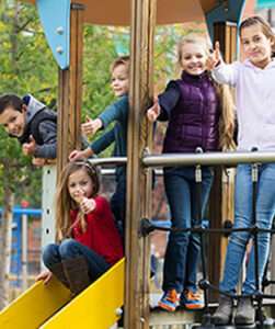 Several elementary children on a playground set