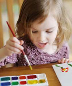 Young girl with brown hair painting