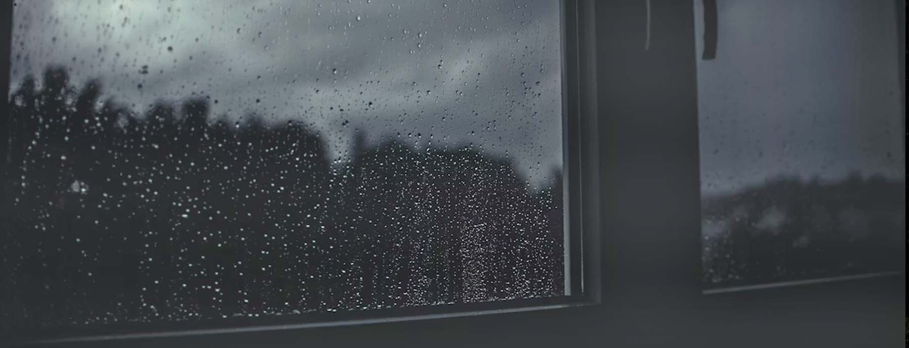 looking through a window on a dark, rainy day